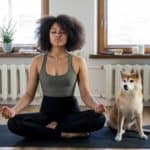 woman meditates with her dog